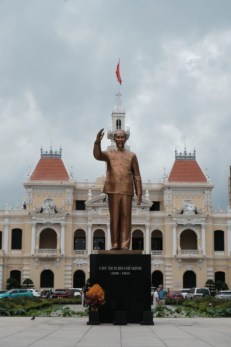 The statue of Ho Chi Minh stands in front of the city's ornate City Hall.