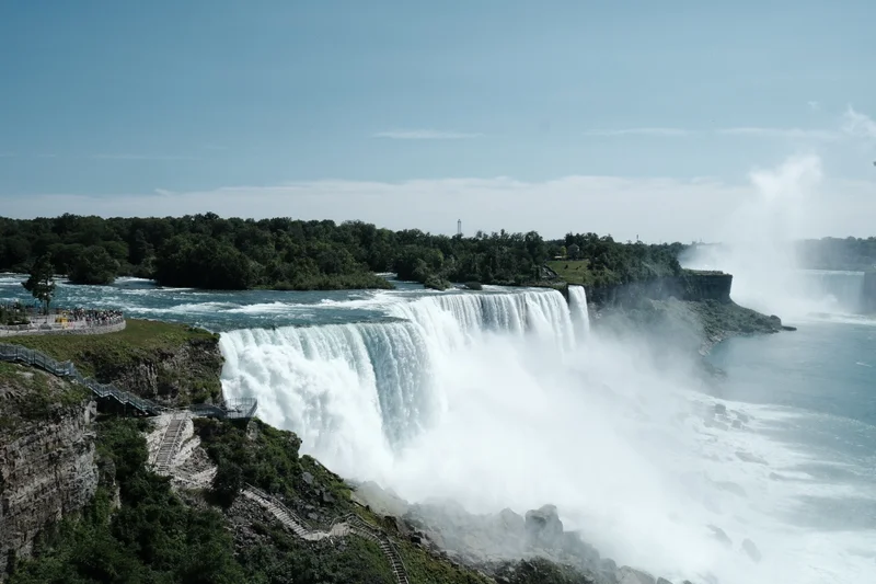 Mist rises above Niagara Falls as the river spills over the edge.